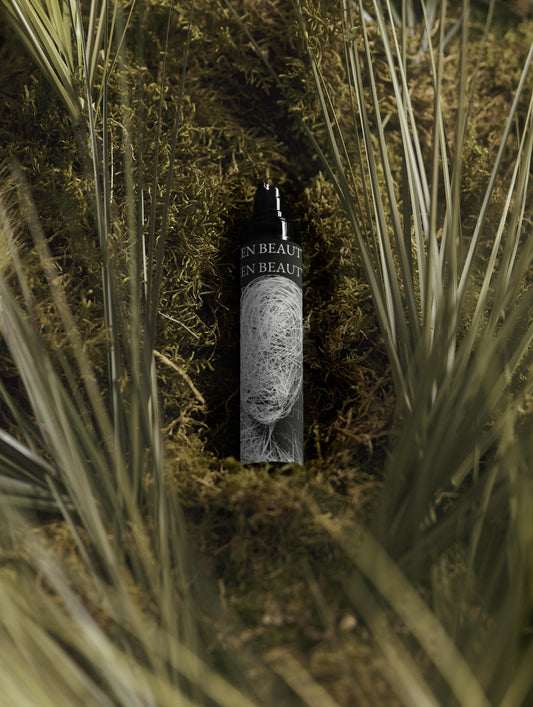 Bottle of Men Beauty in a natural setting with plant, Moisturising Day Cream.