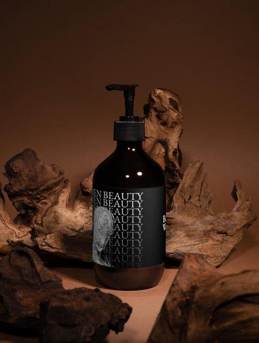 Bottle labeled 'MEN BEAUTY' surrounded by natural wood elements on a brown background, body wash.