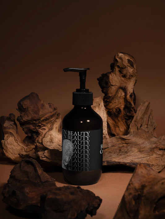 Black bottle with pump dispenser labeled 'Men Beauty' on a brown background with natural wood, elements, hand cream.