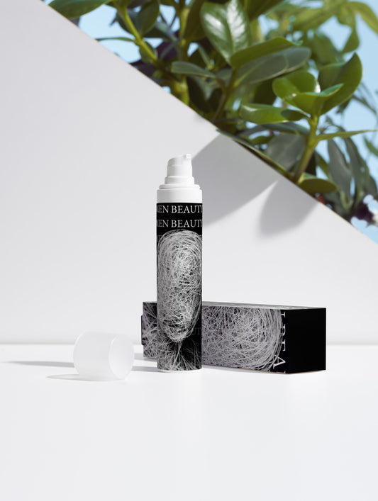 Skincare bottle and packaging with greenery in the background Niacinamide Gel.
