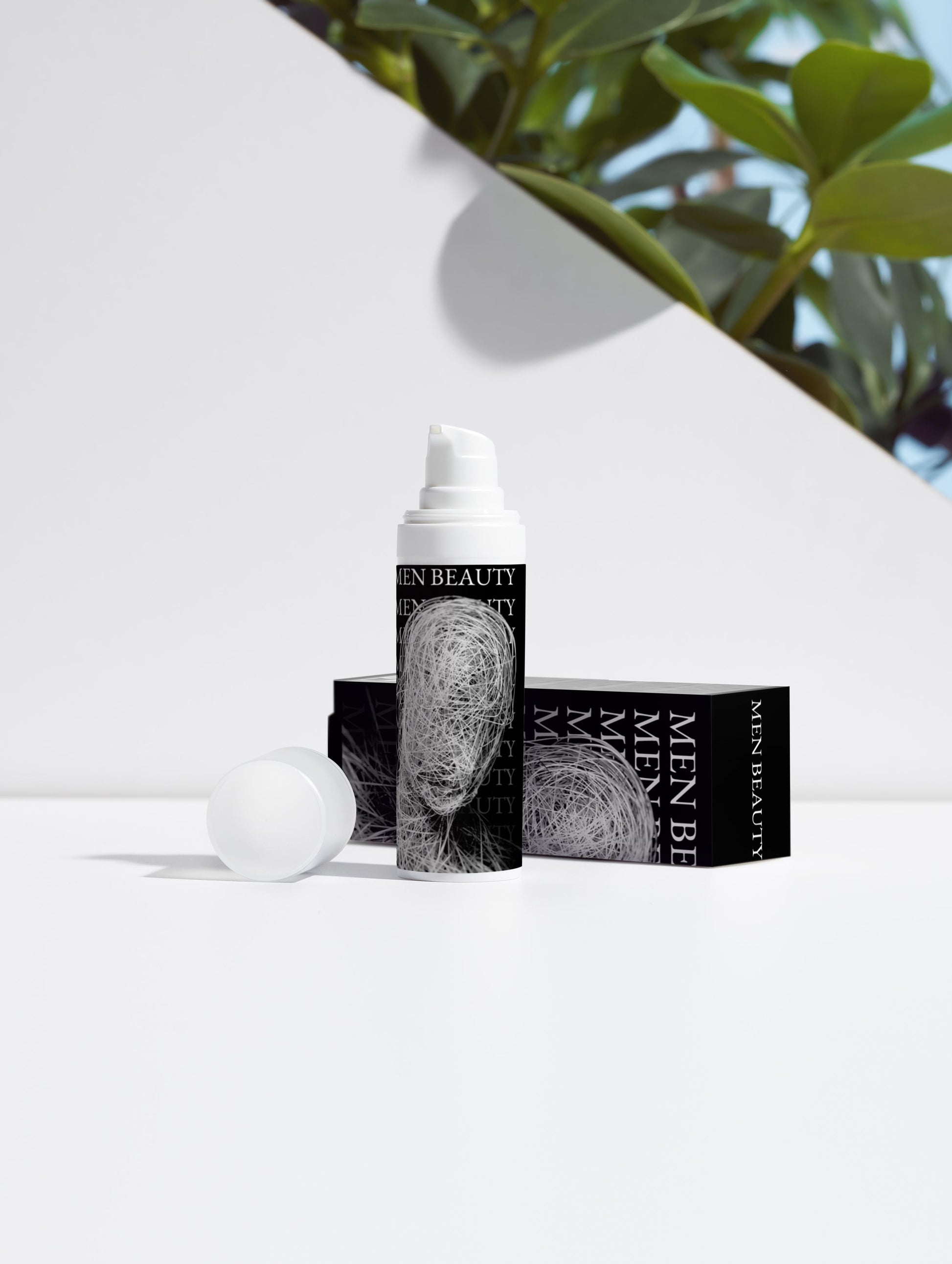 Men's skincare product with packaging on a white surface with greenery in the background, Vitamin C Serum.