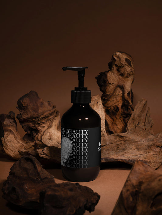 Black bottle with pump dispenser on a wooden surface, body serum.
