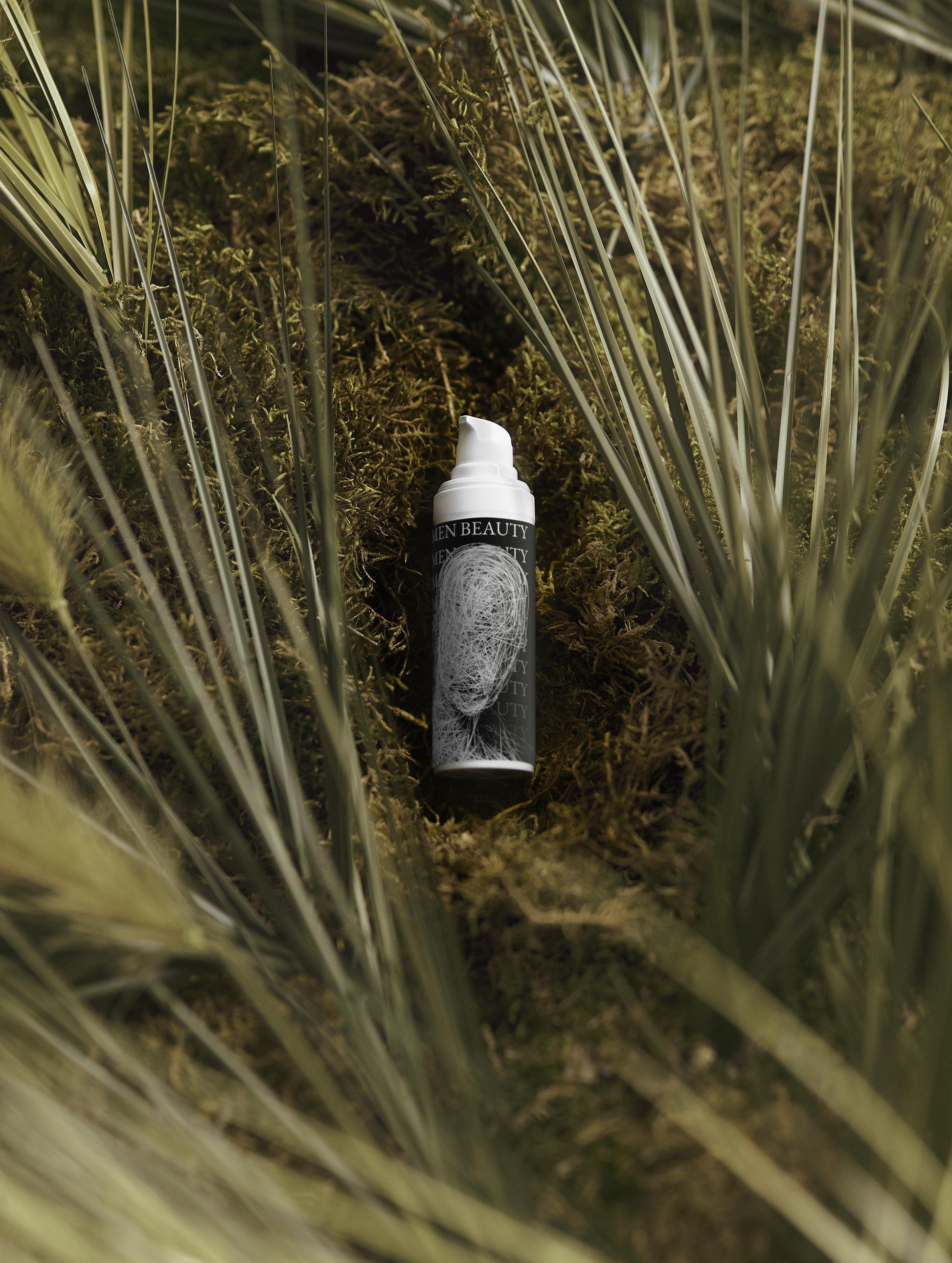 Skincare bottle with a face on it lying on grass, Vitamin C Serum.