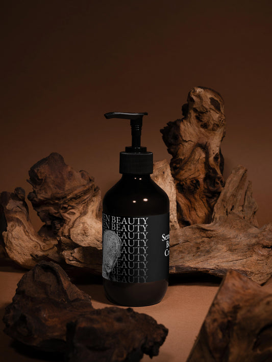 Black bottle with pump dispenser on a brown background with natural wood elements, body cream.