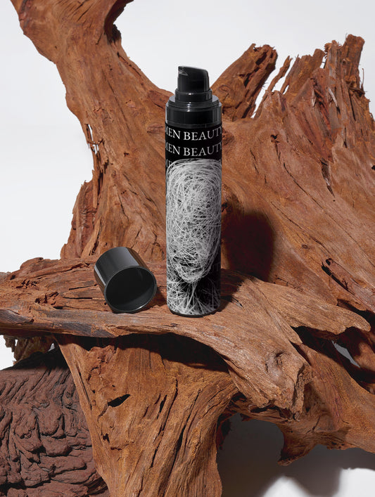 Skincare bottle with black cap and label on a wooden surface, Moisturising Day Cream.