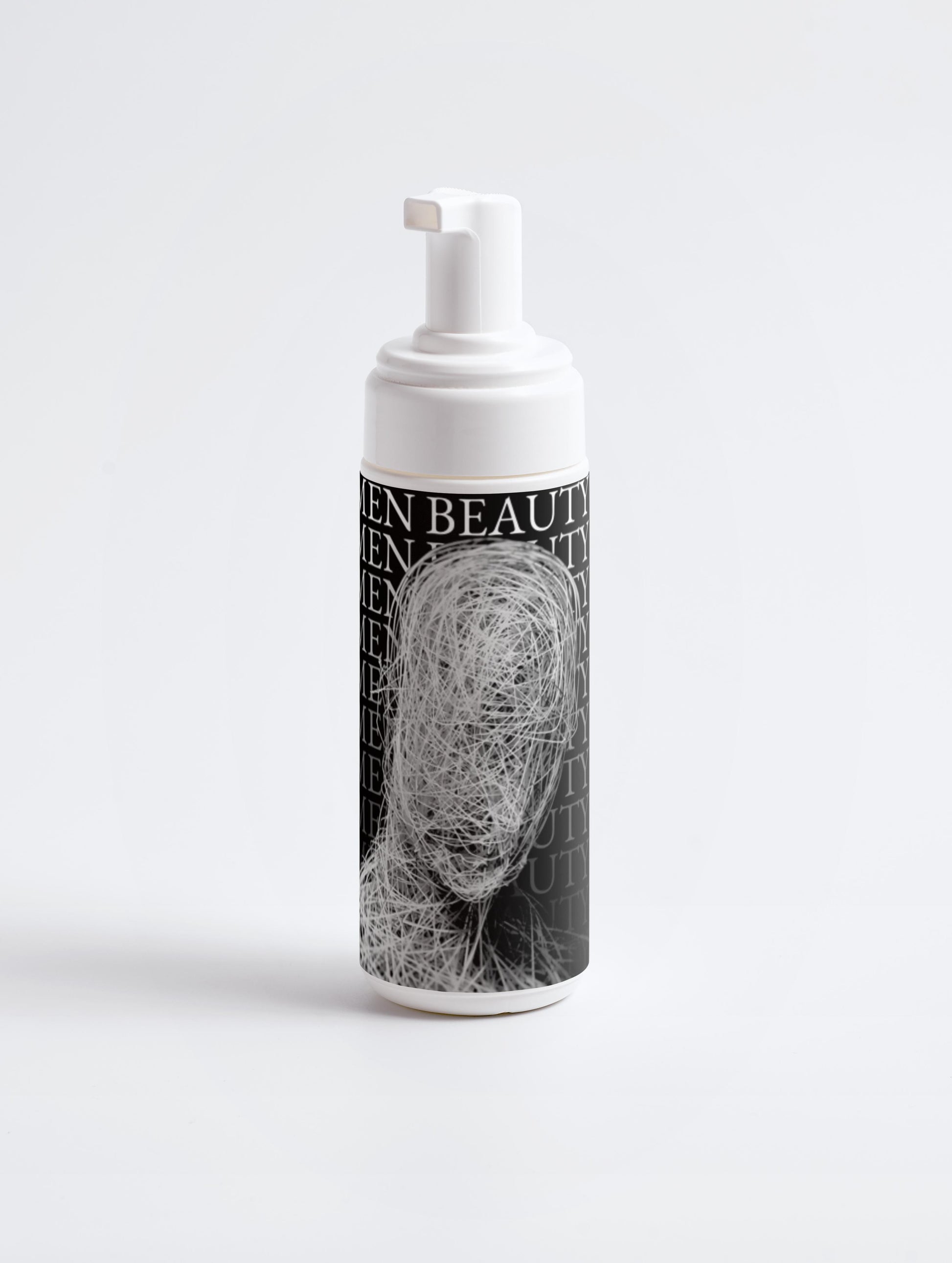 Foam pump bottle with a black and white label featuring a face on a light gray background, Cleansing Foam.